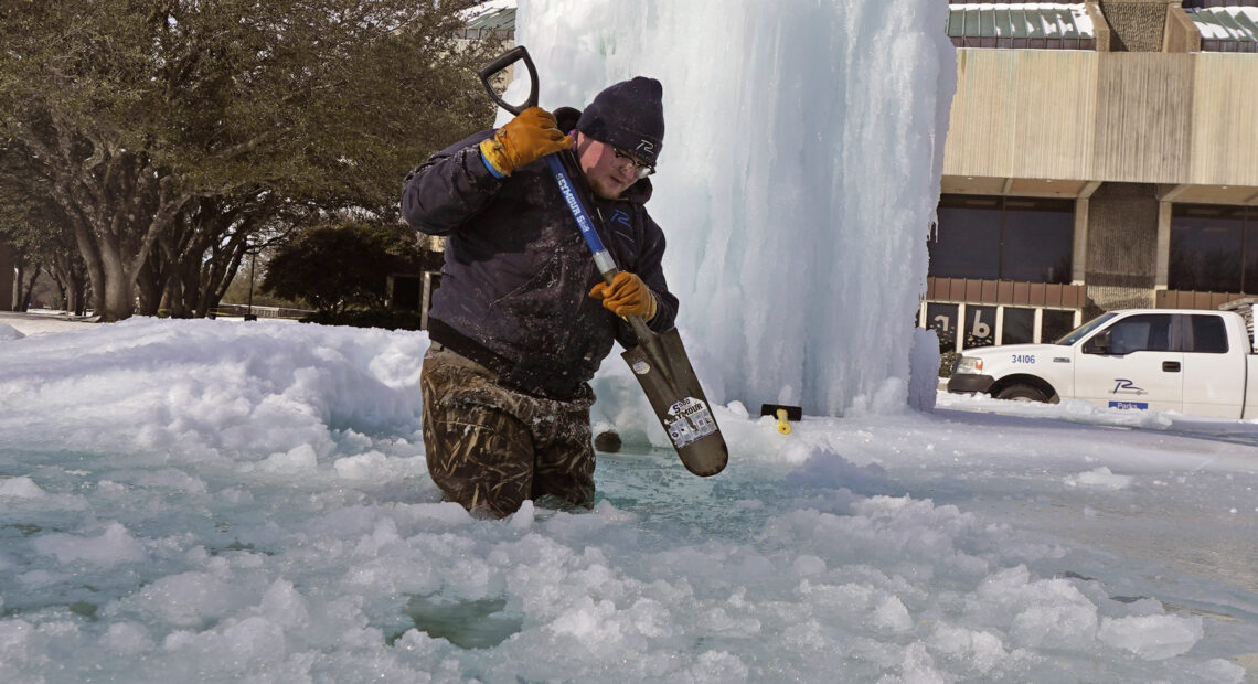 City of Richardson worker Kaleb Love breaks ice on a frozen fountain Tuesday, Feb. 16, 2021, in Richardson, Texas. Temperatures dropped into the single digits as snow shut down air travel and grocery stores. CREDIT: AP Photo/LM Otero