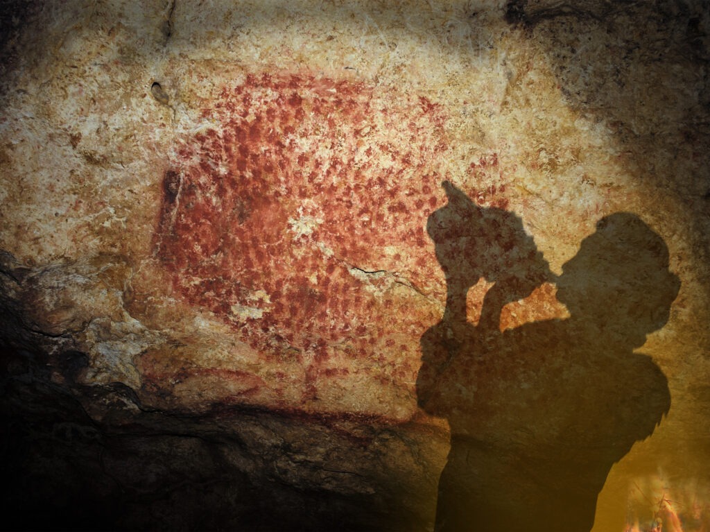 An artist's rendition of the conch of Marsoulas being played in a cave where it was found by researchers in the early 20th Century. CREDIT: G. Tosello
