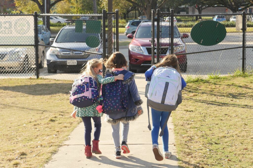 School children wearing facemasks walk outside Condit Elementary School near Houston in December. The U.S. Department of Education announced Friday that it will begin collecting data on the status of in-person learning during the pandemic. François Picard/AFP via Getty Images