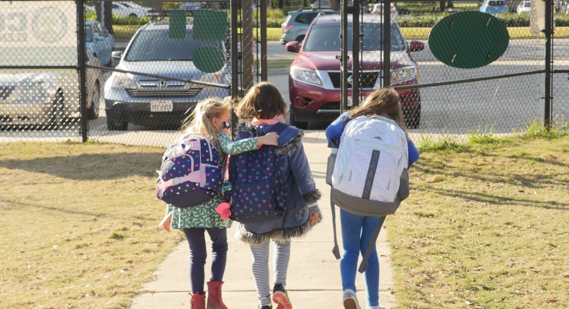 School children wearing facemasks walk outside Condit Elementary School near Houston in December. The U.S. Department of Education announced Friday that it will begin collecting data on the status of in-person learning during the pandemic. François Picard/AFP via Getty Images