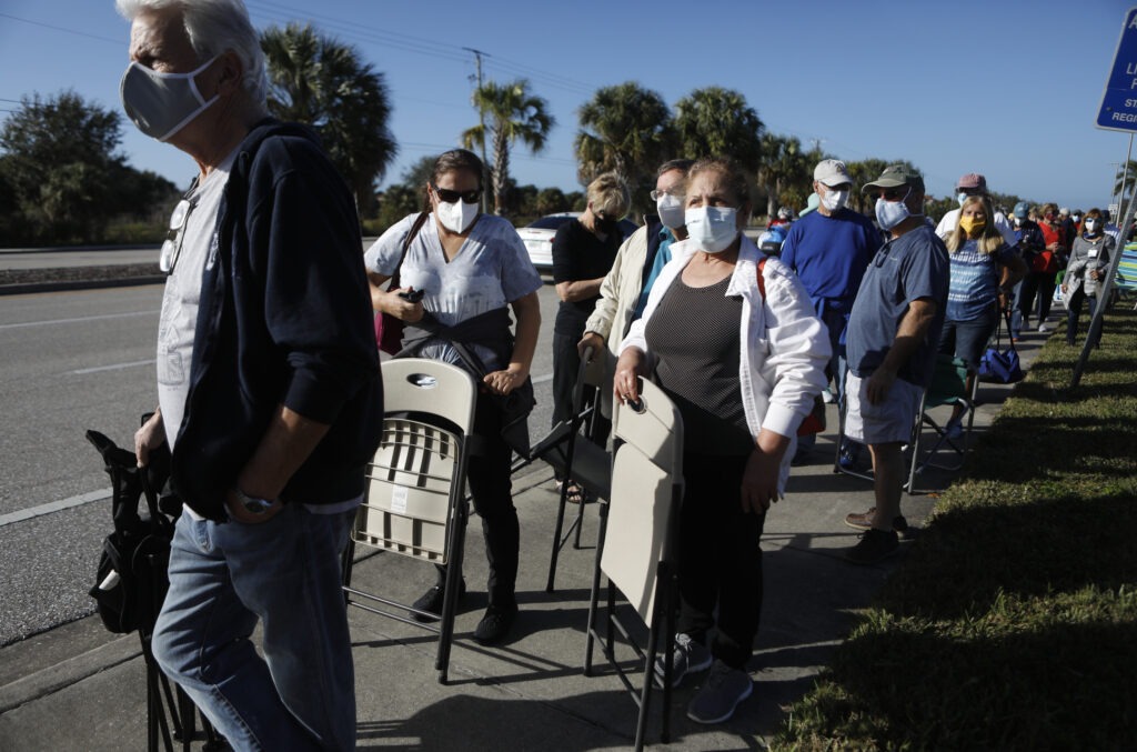 Seniors and first responders try to snag one of 800 doses available at a vaccination site in Fort Myers, Fla. Octavio Jones/Getty Images