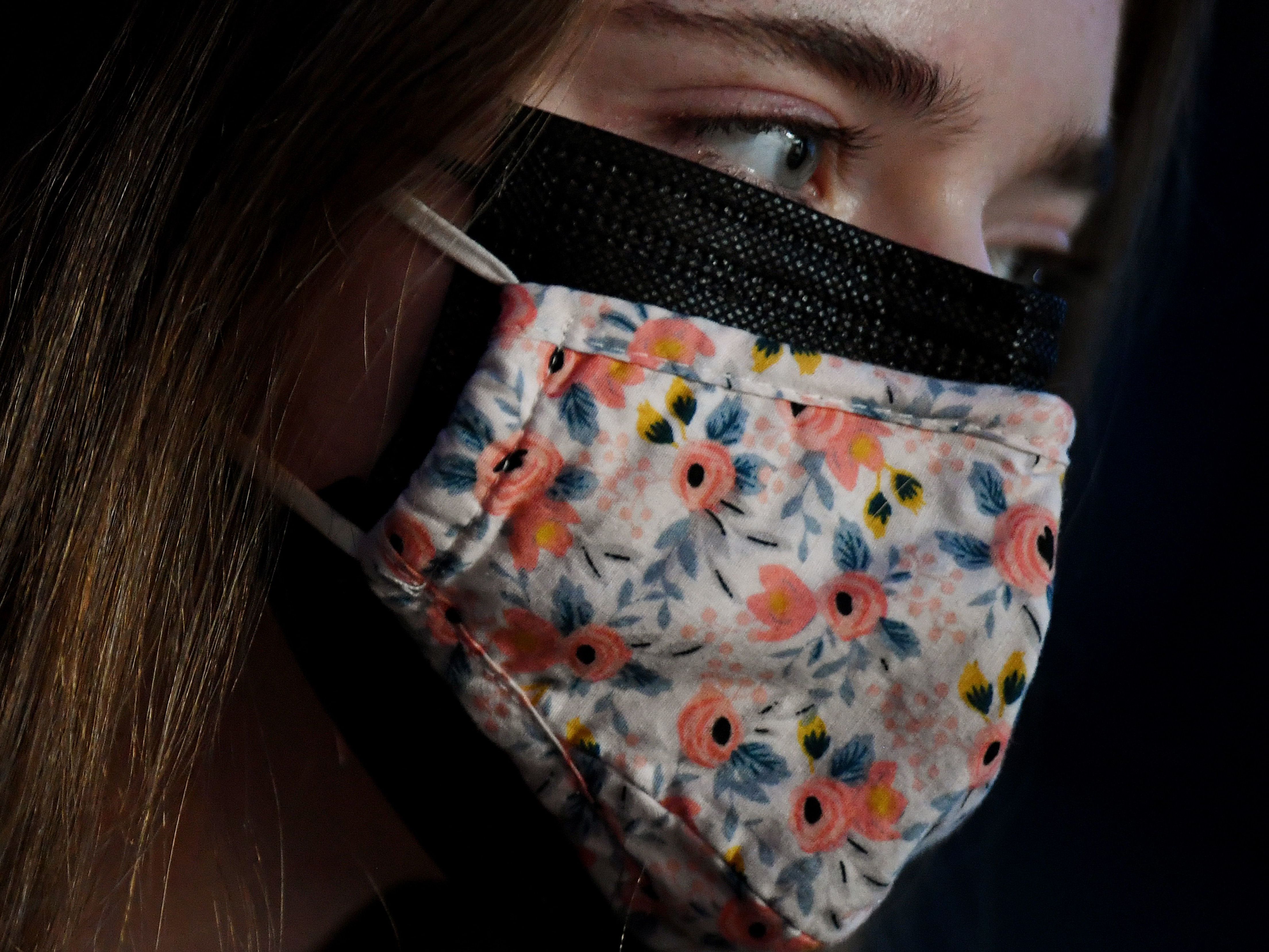 As new, more This illustration shows a woman wearing two facemasks, a cloth mask over a surgical mask, in Arlington, Virginia, on February 8, 2021. - As new, more transmissible variants of the coronavirus spread, experts say it's time to consider using a medical-grade respirator, or wearing a surgical and cloth mask together. Scientists have agreed for some time the main way the virus is spread is through the air, rather than surfaces, and there's growing evidence that small droplets from ordinary breathing and speech that can travel many meters (yards) are a common mode of transmission. (Photo by OLIVIER DOULIERY / AFP) (Photo by OLIVIER DOULIERY/AFP via Getty Images)transmissible variants of the coronavirus spread, the CDC says wearing a cloth mask over a surgical mask offers increased protection against the virus. Olivier Douliery/AFP via Getty Images