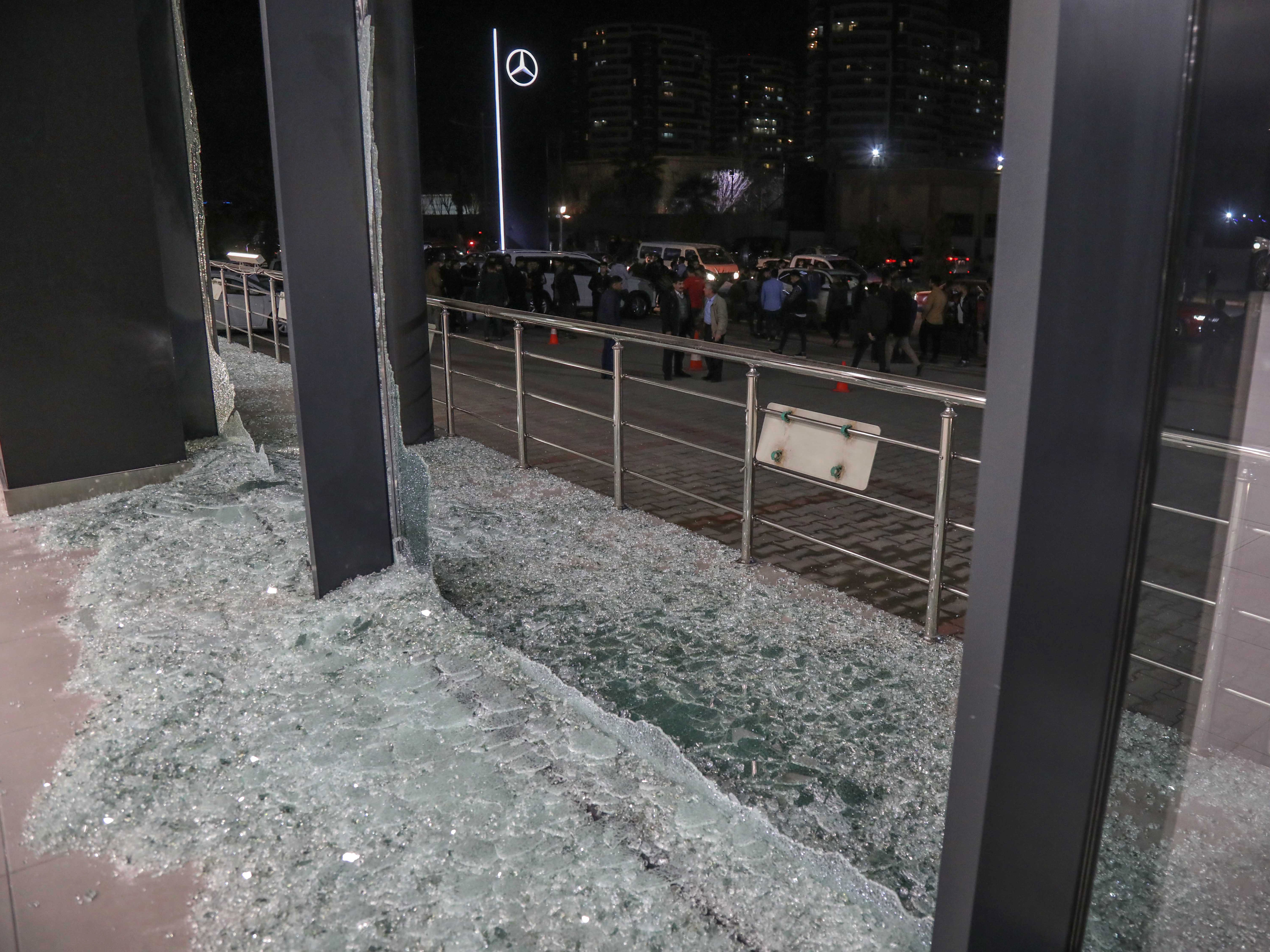 Shattered glass is on the ground following a rocket attack in Irbil, the capital of the northern Iraqi Kurdish autonomous region, on Feb. 15. On Thursday, the U.S. launched airstrikes targeting Iranian-backed groups in eastern Syria in response to recent attacks against Americans in Iraq. Safin Hamed/AFP via Getty Images