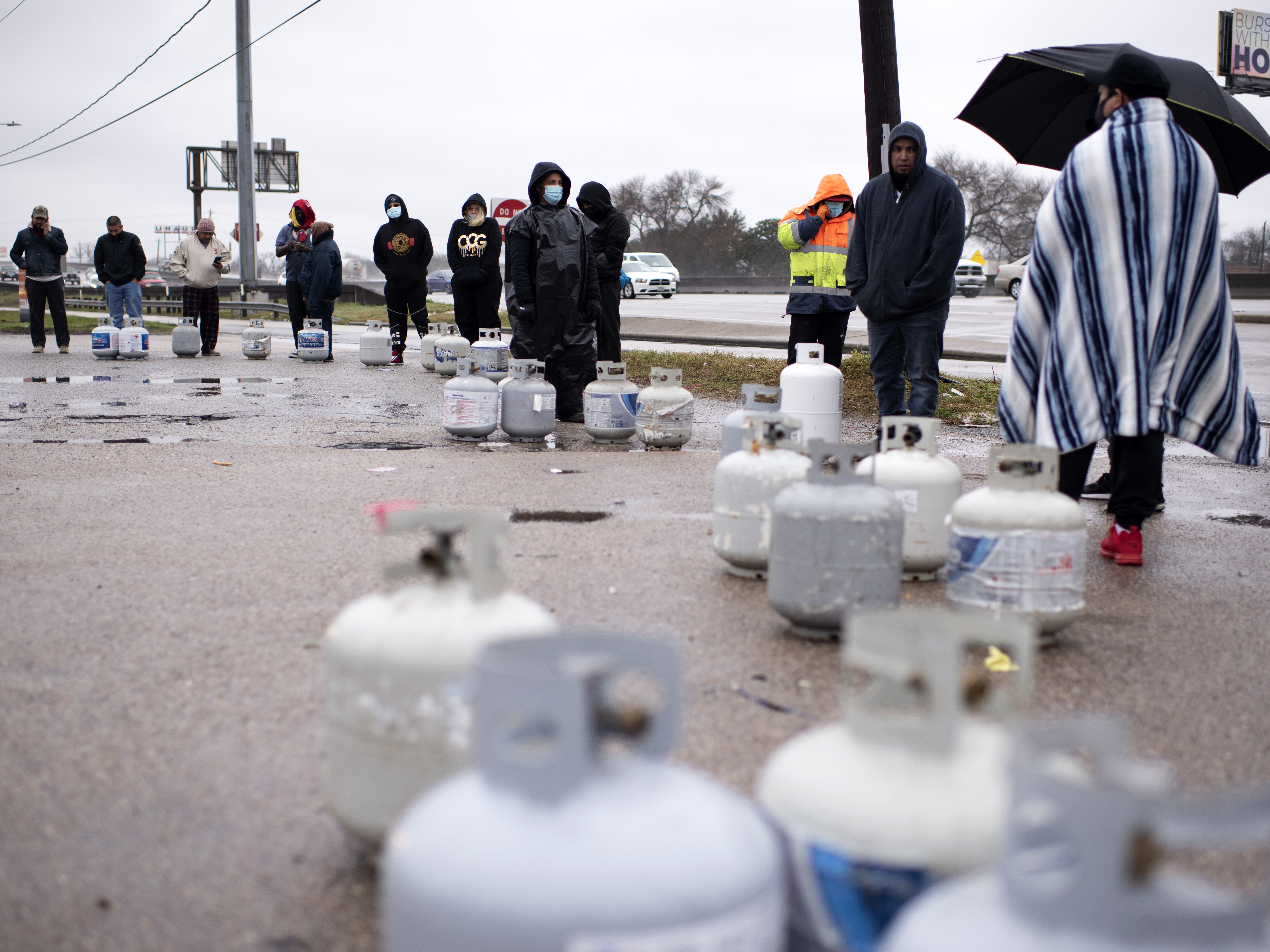 People in Houston wait in line to fill their propane tanks on Wednesday amidst widespread power outages related to the winter storm. Cases of carbon monoxide poisoning in the state have increased in recent days, with officials attributing most to the improper use of heating devices like charcoal grills and portable generators. CREDIT: Mark Felix/The Washington Post via Getty Images