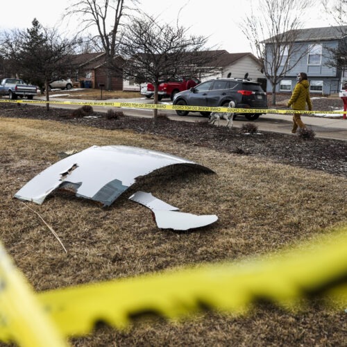 Pieces of an engine from United Airlines Flight 328 sit scattered in a neighborhood after the jet's engine failure on Saturday after takeoff from Denver. CREDIT: Michael Ciaglo/Getty Images