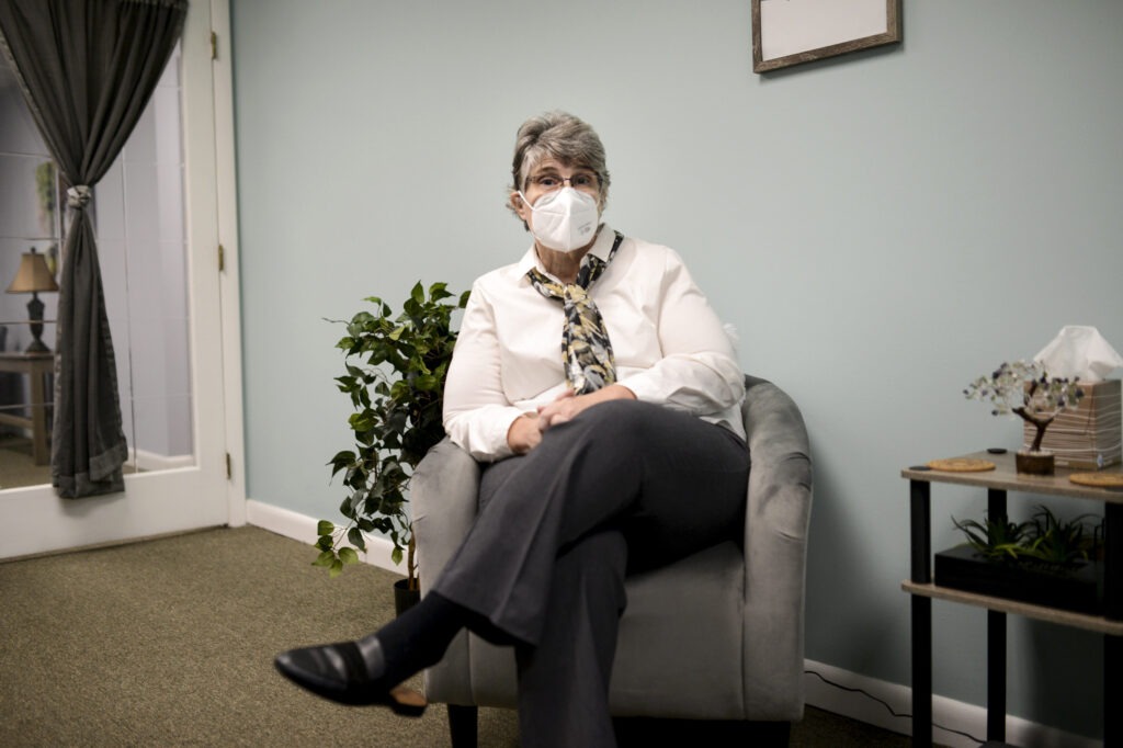 Jodee Pineau-Chaisson sits in her office in Springfield, Mass. on January 12, 2021. Pineau-Chaisson, a social worker, contracted the coronavirus last May and continues to have symptoms even months after testing negative for the virus. Meredith Nierman/GBH News