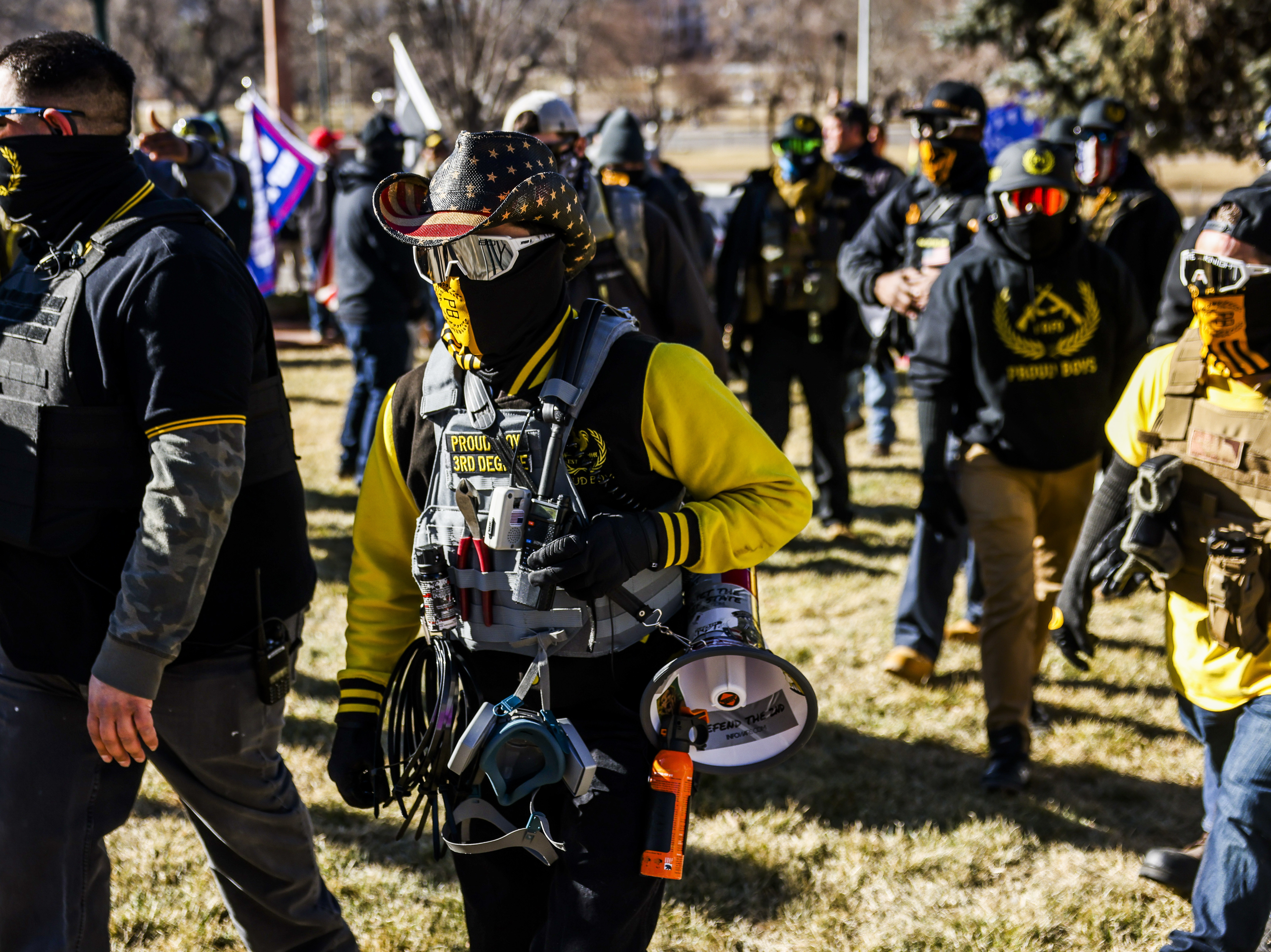 Public Safety Canada notes that last month, members of the Proud Boys "played a pivotal role in the insurrection at the U.S. Capitol." Here, Proud Boys members join Donald Trump supporters at a protest outside the Colorado State Capitol last month in Denver. CREDIT: Michael Ciaglo/Getty Images