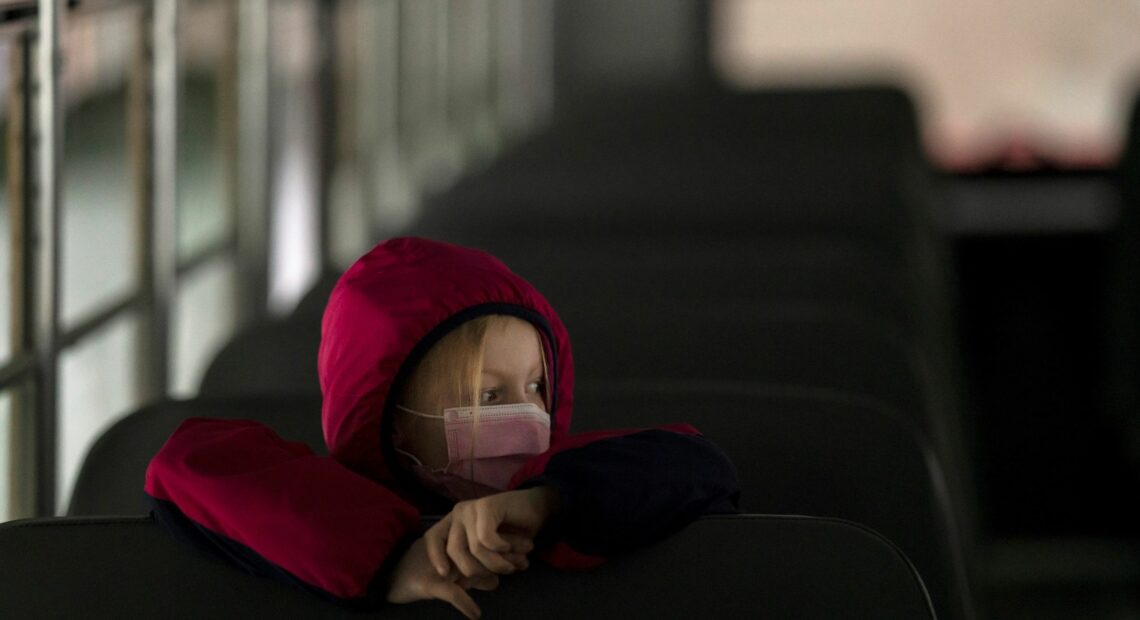 A first-grade student sits on the bus after a day of classes in Woodland, Wash., on Thursday. Nathan Howard/Getty Images