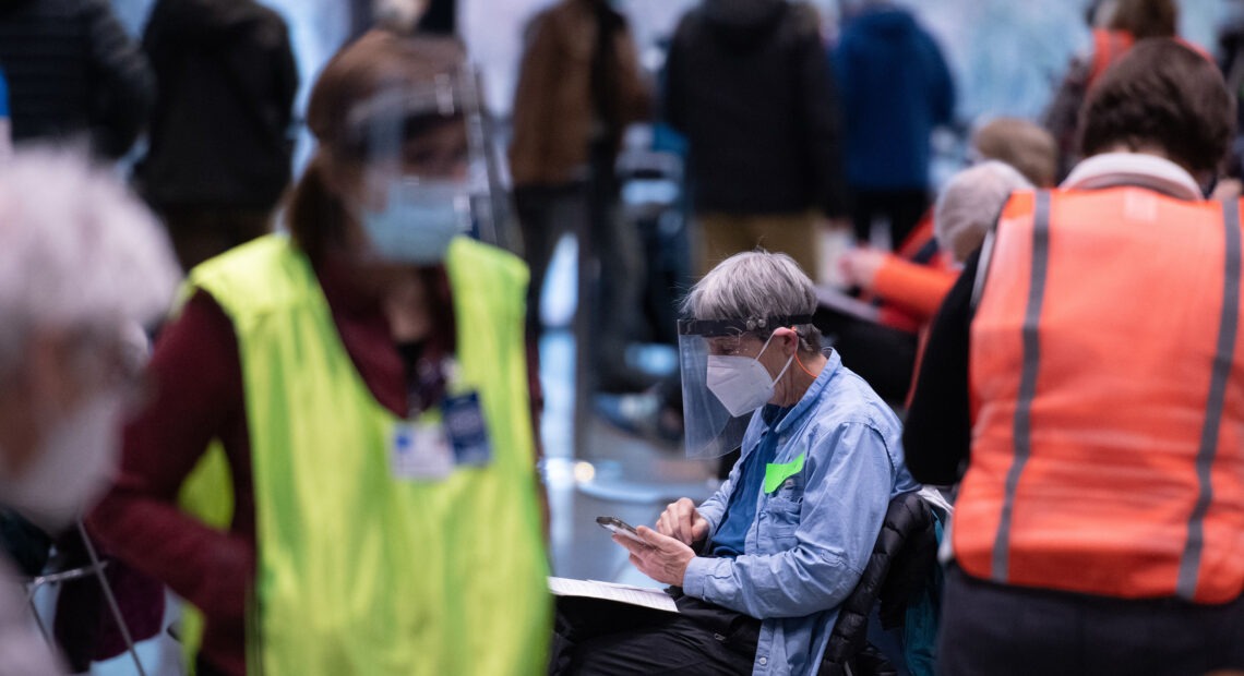Workers and patients at a pop-up COVID-19 vaccination site near downtown Seattle in January. "The vast majority who are coming in do appear to be meeting the eligibility criteria," says Dr. Jeff Duchin, King County's public health officer. Grant Hindsley/AFP via Getty Images