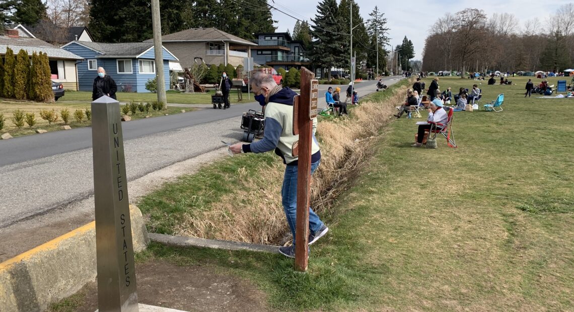 Crossing the border into Peace Arch State Park from Canada, at left, entails stepping across a ditch. CREDIT: Tom Banse/N3