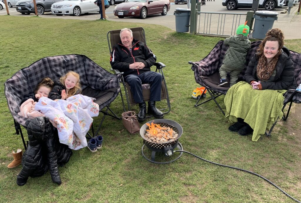 Canadian grandpa Jack Wilson, center, had not seen his American grandchildren including Zoe, second from left, for more than a year until the extended family gathered at the U.S.-Canada border. CREDIT: Tom Banse/N3