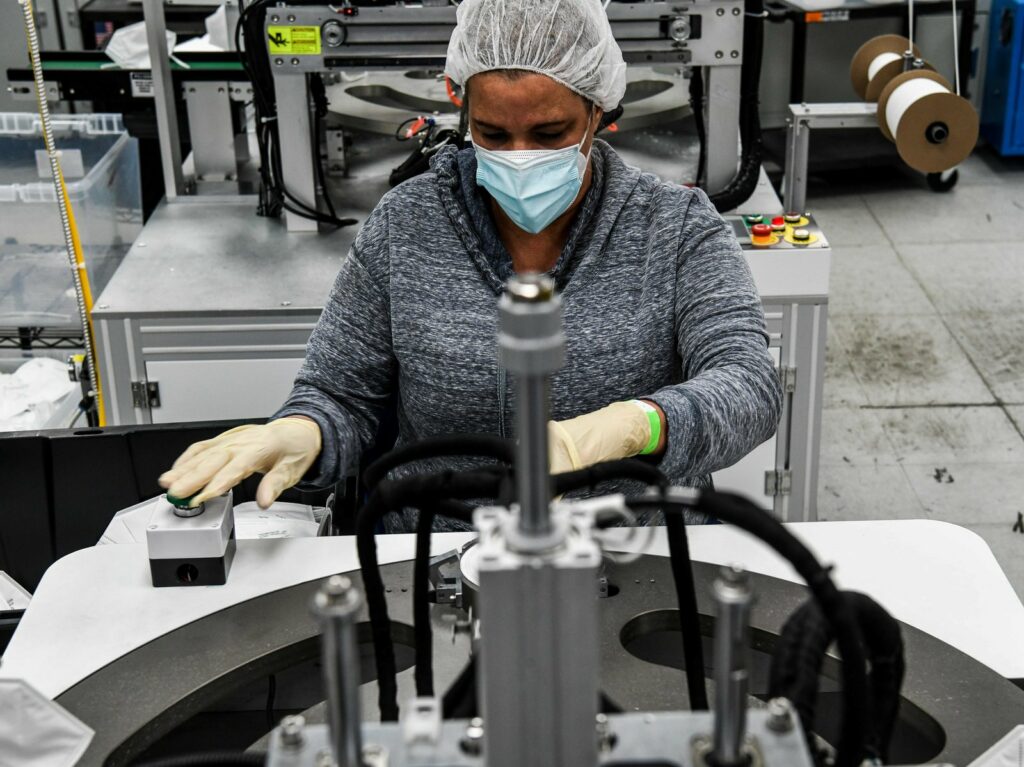 An employee makes respiratory masks in a family-owned medical equipment factory in Miami on Feb. 15. American manufacturers are thriving but they are running into an unexpected problem: finding critical supplies. CREDIT: Chandan Khanna/AFP via Getty Images