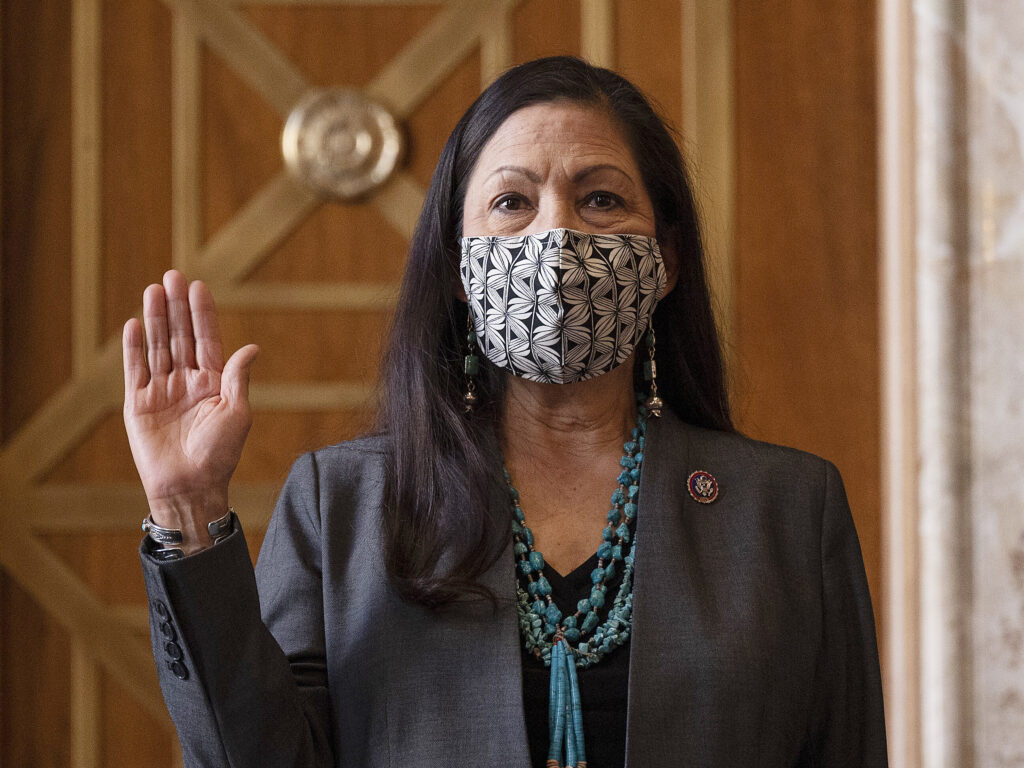 Rep. Deb Haaland, D-N.M., is sworn in before her Senate confirmation hearing to be Interior Secretary last month. Her confirmation makes her the country's first Native American cabinet secretary. CREDIT: Jim Watson/AP