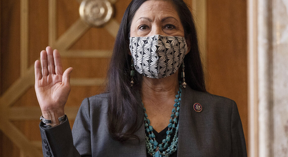 Rep. Deb Haaland, D-N.M., is sworn in before her Senate confirmation hearing to be Interior Secretary last month. Her confirmation makes her the country's first Native American cabinet secretary. CREDIT: Jim Watson/AP