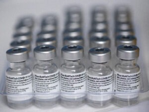 Empty Pfizer COVID-19 vaccine vials are collected in a tray to be destroyed to prevent them from being resold or refilled, at a vaccination center in the Victor Jara Stadium in Santiago, Chile, Tuesday, March 30, 2021. (AP Photo/Esteban Felix)