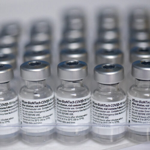 Empty Pfizer COVID-19 vaccine vials are collected in a tray to be destroyed to prevent them from being resold or refilled, at a vaccination center in the Victor Jara Stadium in Santiago, Chile, Tuesday, March 30, 2021. (AP Photo/Esteban Felix)