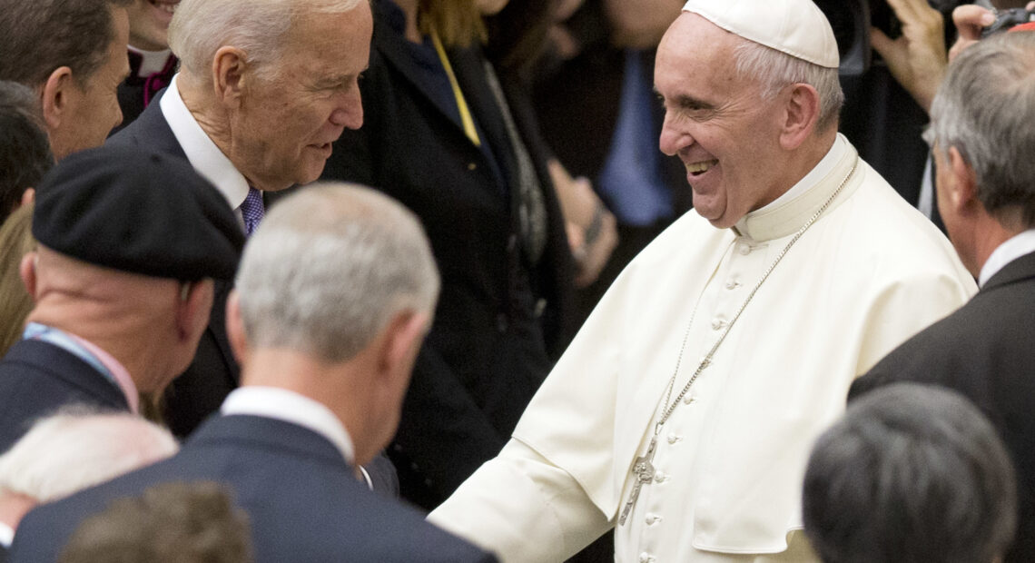 Pope Francis shakes hands with Joe Biden, then vice president, at the Vatican, in 2016. Andrew Medichini/AP