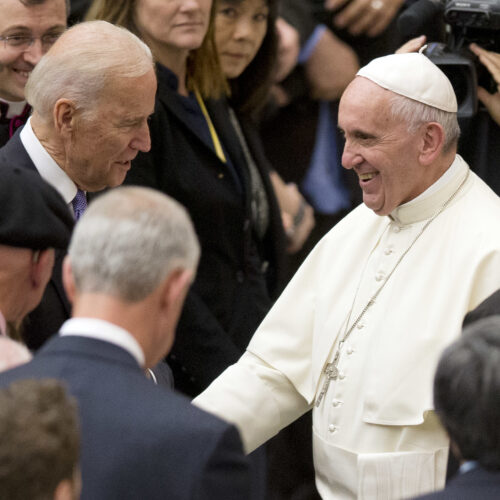 Pope Francis shakes hands with Joe Biden, then vice president, at the Vatican, in 2016. Andrew Medichini/AP