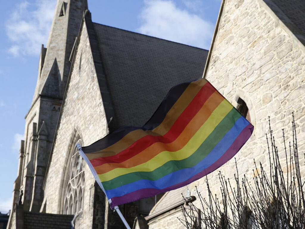An LGBTQ+ flag flies over Union United Methodist Church in the South End of Boston on Jan. 5, 2020. On Epiphany Sunday, as local Methodists celebrated the visit of the Magi and marked the end of the Christmas season, they were also grappling with the possibility their church could split over a disagreement about LGBTQ participation in the faith. A group of United Methodist Church leaders made headlines Friday when they announced a proposal that would allow conservative congregations opposing same-sex marriage and the ordination of lesbian, gay, bisexual, transgender, and queer clergy to leave the UMC, form a new denomination, maintain their church assets, and get $25 million in the divorce. (Photo by Jessica Rinaldi/The Boston Globe via Getty Images)