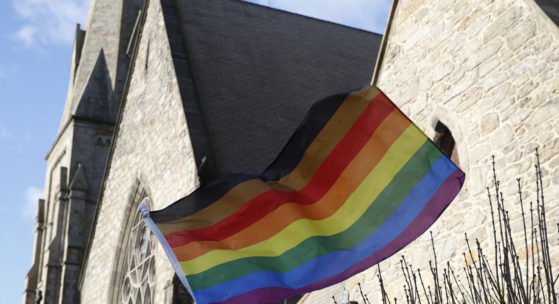 An LGBTQ+ flag flies over Union United Methodist Church in the South End of Boston on Jan. 5, 2020. On Epiphany Sunday, as local Methodists celebrated the visit of the Magi and marked the end of the Christmas season, they were also grappling with the possibility their church could split over a disagreement about LGBTQ participation in the faith. A group of United Methodist Church leaders made headlines Friday when they announced a proposal that would allow conservative congregations opposing same-sex marriage and the ordination of lesbian, gay, bisexual, transgender, and queer clergy to leave the UMC, form a new denomination, maintain their church assets, and get $25 million in the divorce. (Photo by Jessica Rinaldi/The Boston Globe via Getty Images)