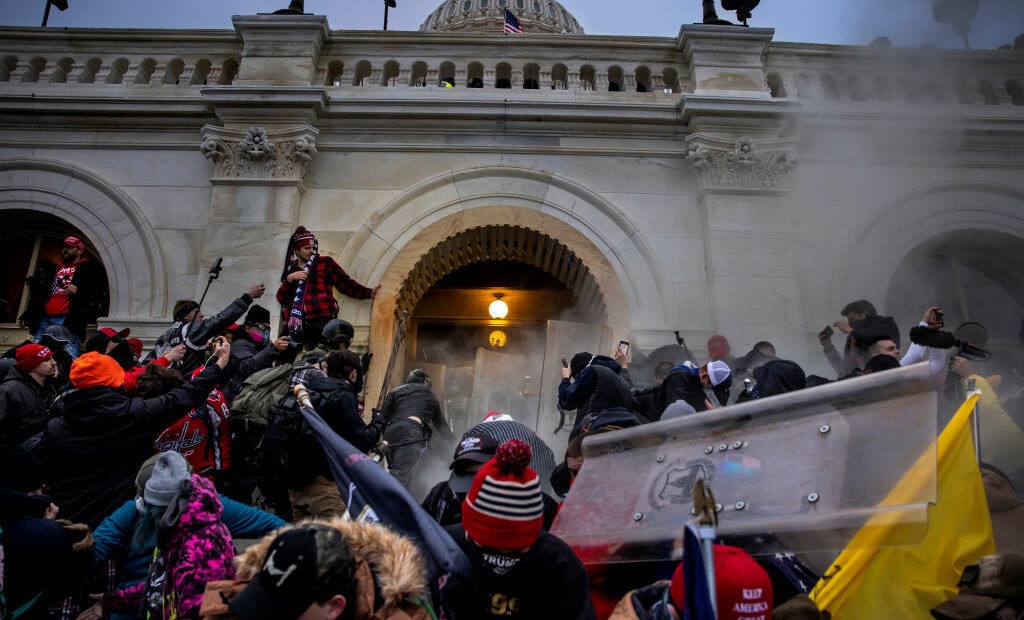 Rioters clash with police and security forces as people storm the U.S. Capitol on Jan. 6. Federal investigators say they expect even more people will be charged in connection with the insurrection. CREDIT: Brent Stirton/Getty Images
