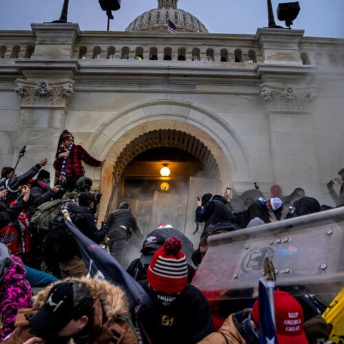 Rioters clash with police and security forces as people storm the U.S. Capitol on Jan. 6. Federal investigators say they expect even more people will be charged in connection with the insurrection. CREDIT: Brent Stirton/Getty Images