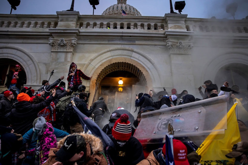 Rioters clash with police and security forces as people storm the U.S. Capitol on Jan. 6. Federal investigators say they expect even more people will be charged in connection with the insurrection. CREDIT: Brent Stirton/Getty Images