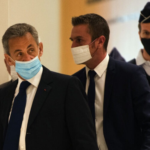 French former President Nicolas Sarkozy (left) arrives to hear the verdict in a corruption trial at Porte de Clichy court house in Paris on Monday. CREDIT: Bloomberg/Bloomberg via Getty Images