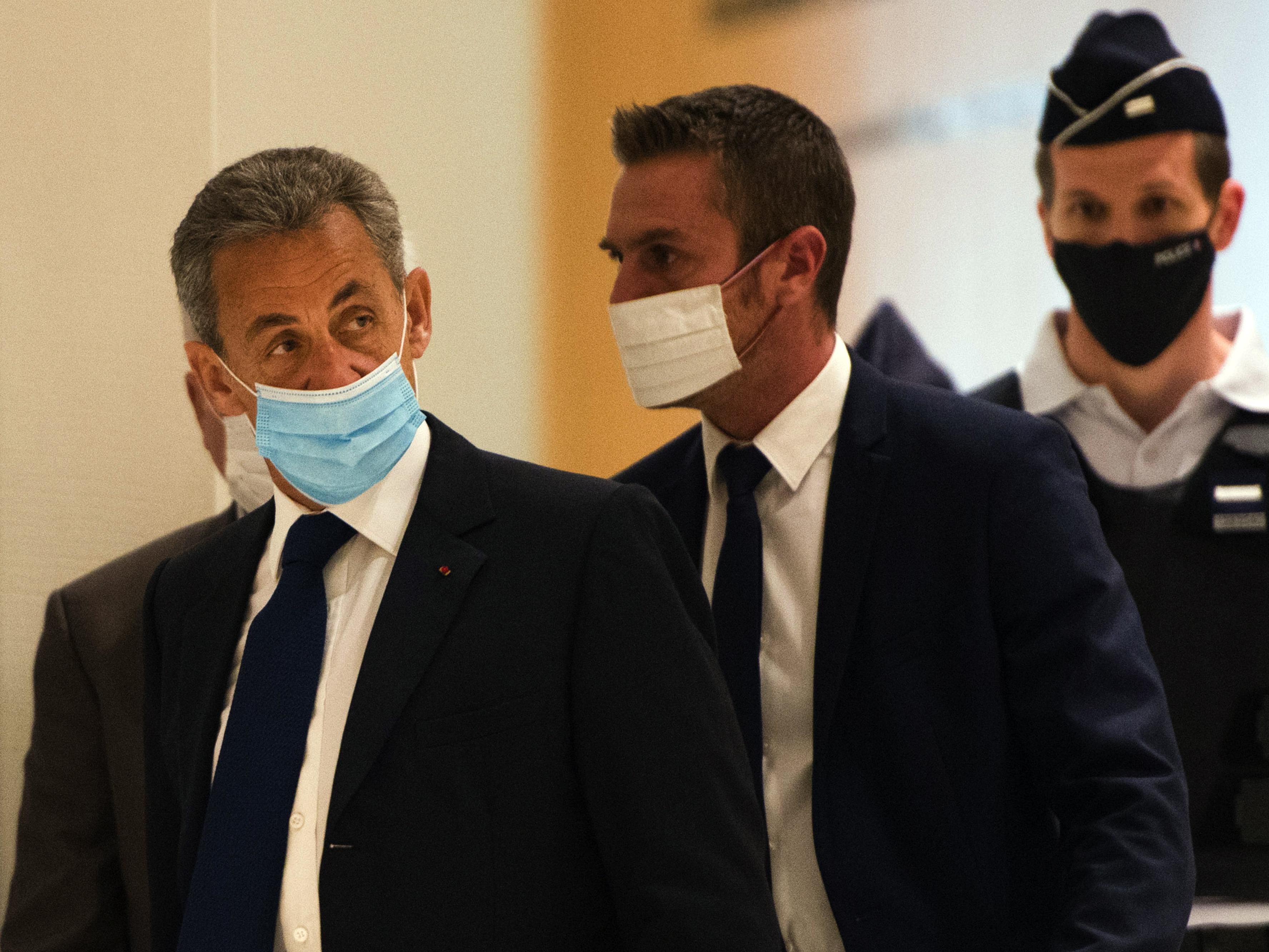 French former President Nicolas Sarkozy (left) arrives to hear the verdict in a corruption trial at Porte de Clichy court house in Paris on Monday. CREDIT: Bloomberg/Bloomberg via Getty Images