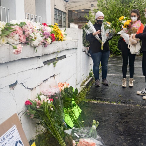 Mourners visit and leave flowers on Wednesday at the site of two shootings at spas across the street from one another in Atlanta. CREDIT: Megan Varner/Getty Images
