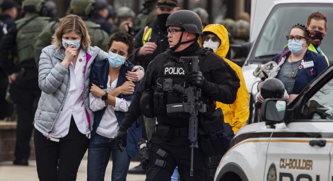 Healthcare workers walk out of a King Sooper's Grocery store after a gunman opened fire on Monday in Boulder, Colo. CREDIT: Chet Strange/Getty Images