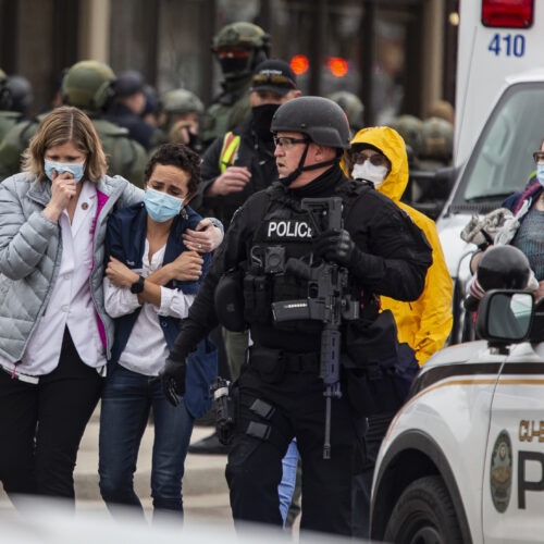 Healthcare workers walk out of a King Sooper's Grocery store after a gunman opened fire on Monday in Boulder, Colo. CREDIT: Chet Strange/Getty Images