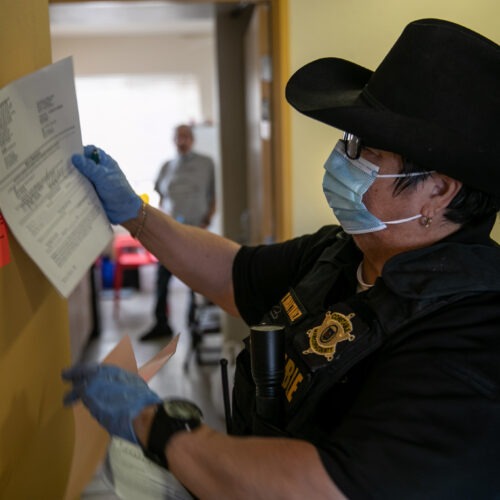 Constable placing eviction notice on door in Texas