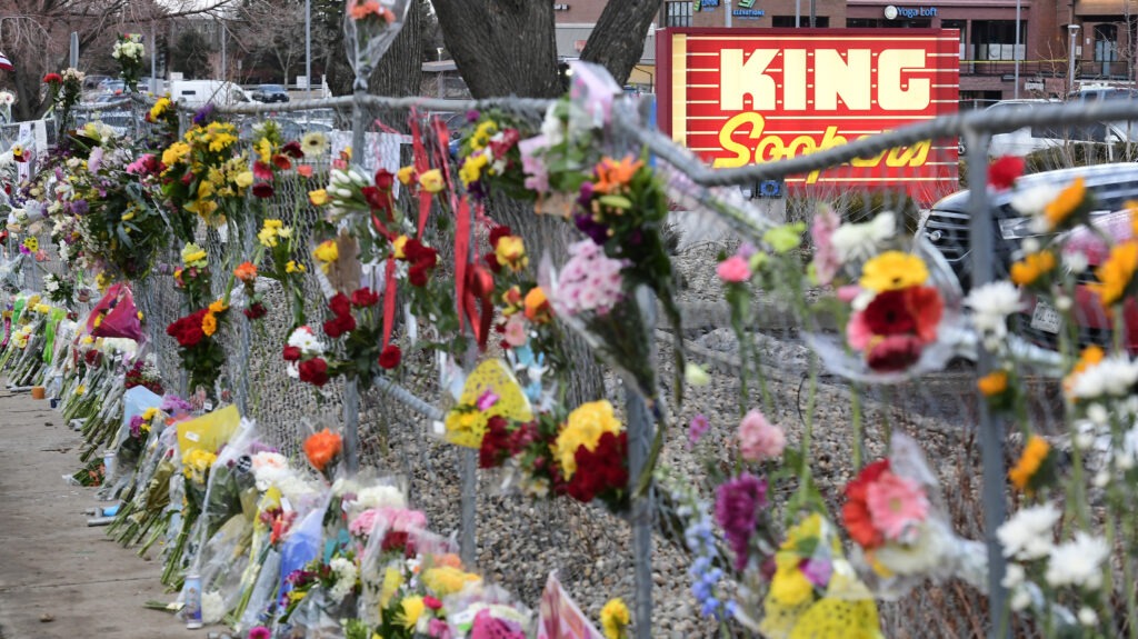 A memorial with flowers for victims of the Boulder King Sooper shooting 