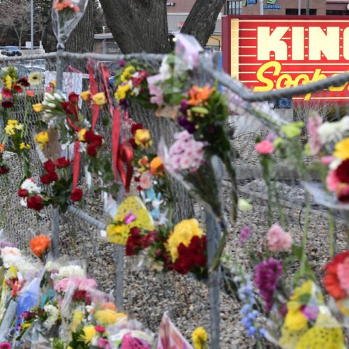 A memorial with flowers for victims of the Boulder King Sooper shooting