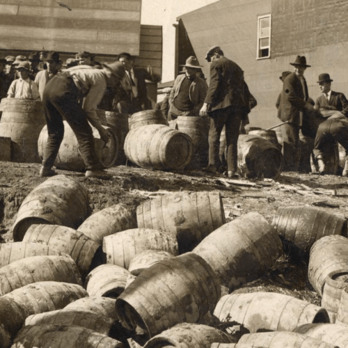 Men spilling barrels of liquor during Prohibition.