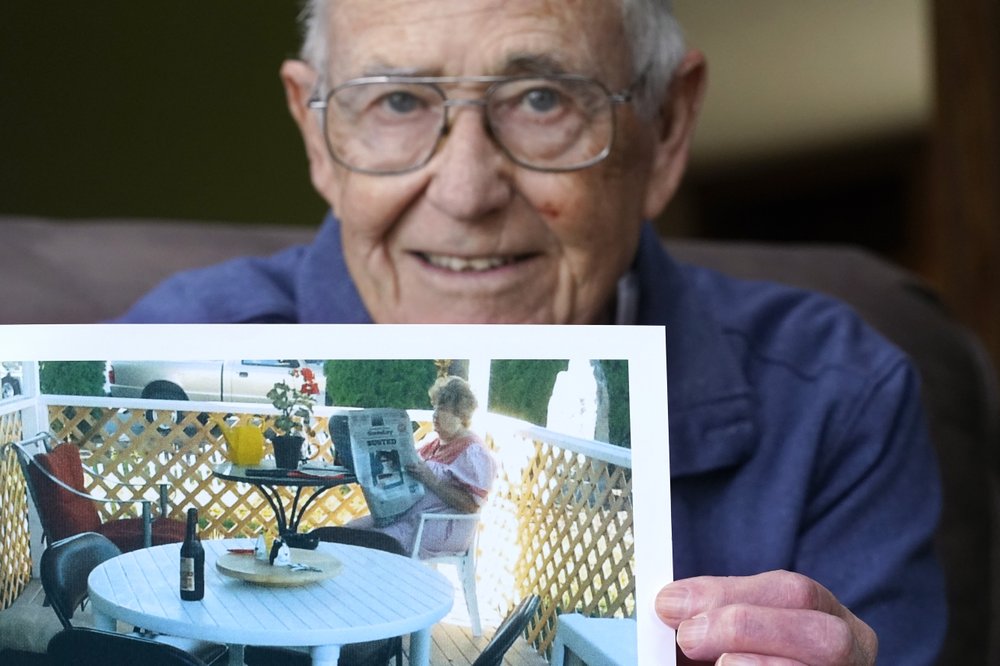 Victor Hamilton displays a photo of his late wife, Nancy "Nicki" Hamilton, who died about a year earlier after contracting COVID-19 at a choir practice, Thursday, April 8, 2021, at his home in Mount Vernon, Wash. The choir practice in sickened 53 people and killed two, becoming one of the first known COVID-19 superspreader events in the United States. CREDIT: Elaine Thompson/AP