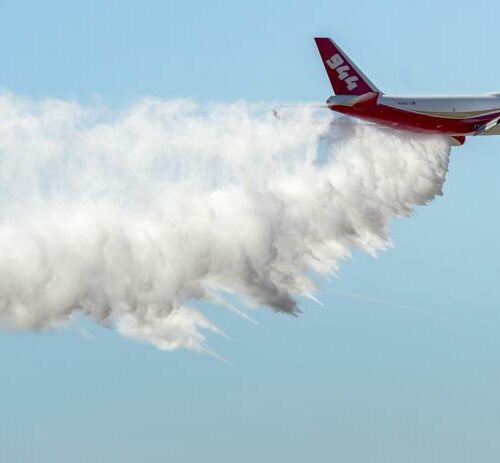 In this May 5, 2016, a Boeing 747-400 Global SuperTanker drops half a load of its 19,400-gallon capacity during a ceremony at Colorado Springs, Colo. The world’s largest firefighting plane has been shut down just as Western states prepare for a wildfire season that fire officials fear could be worse than the average year. CREDIT: Christian Murdock/The Gazette via AP