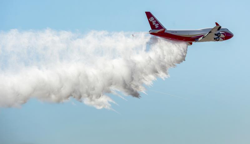 In this May 5, 2016, a Boeing 747-400 Global SuperTanker drops half a load of its 19,400-gallon capacity during a ceremony at Colorado Springs, Colo. The world’s largest firefighting plane has been shut down just as Western states prepare for a wildfire season that fire officials fear could be worse than the average year. CREDIT: Christian Murdock/The Gazette via AP