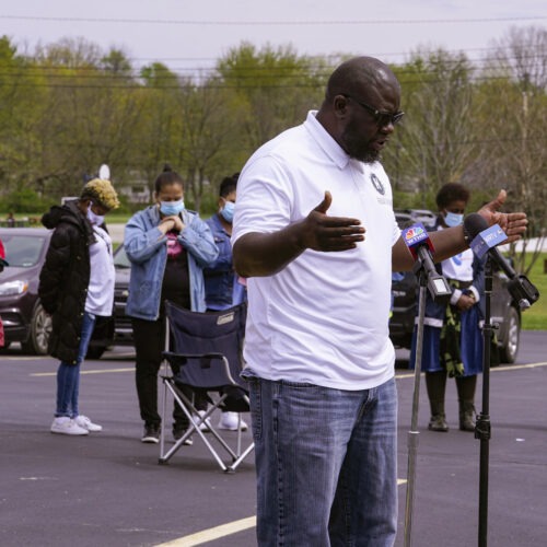 Pastor Denell Howard leads a prayer Saturday at a vigil at Olivet Missionary Baptist Church in Indianapolis for the victims of the shooting Thursday at a FedEx facility. CREDIT: Michael Conroy/AP