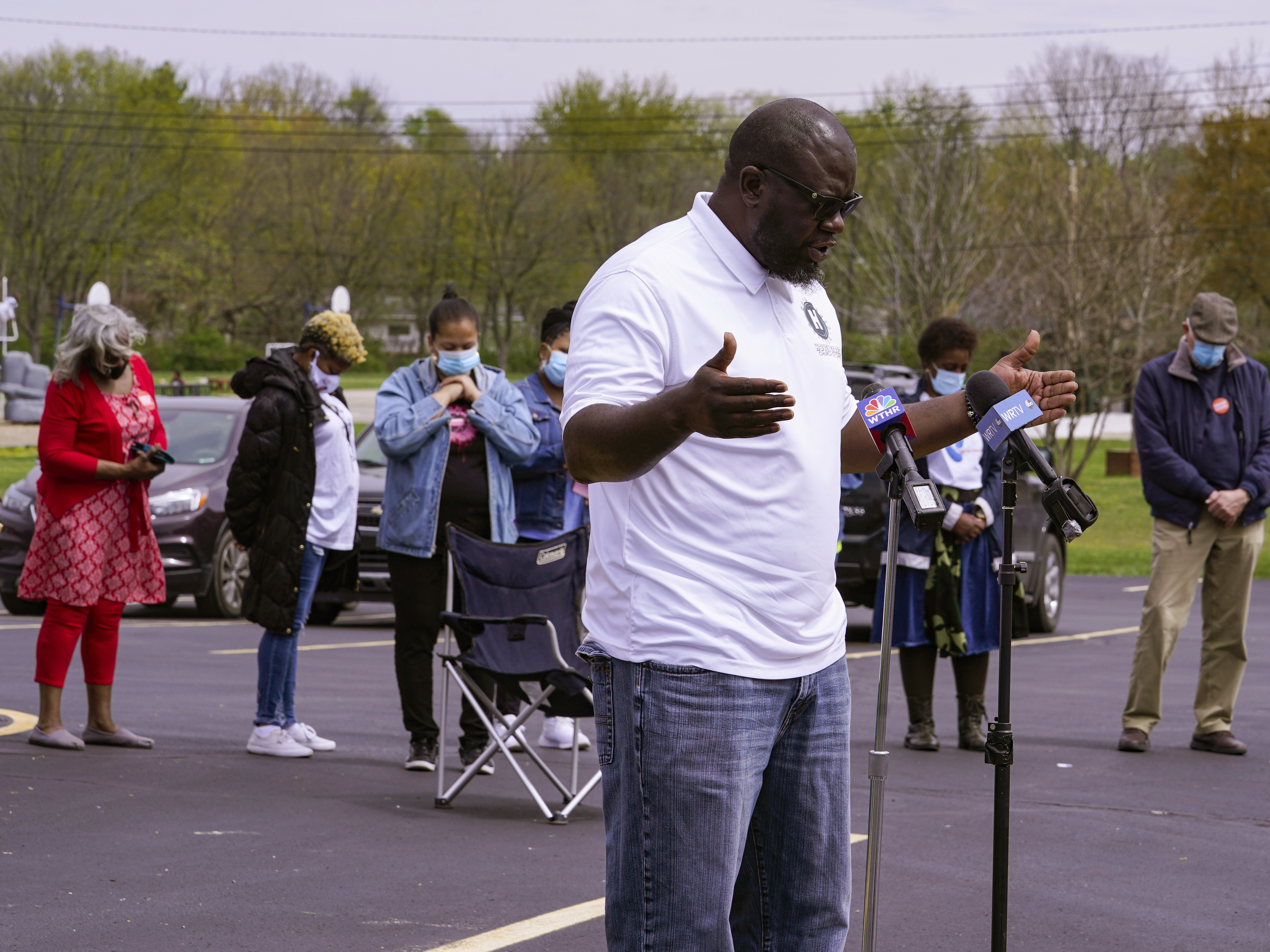 Pastor Denell Howard leads a prayer Saturday at a vigil at Olivet Missionary Baptist Church in Indianapolis for the victims of the shooting Thursday at a FedEx facility. CREDIT: Michael Conroy/AP