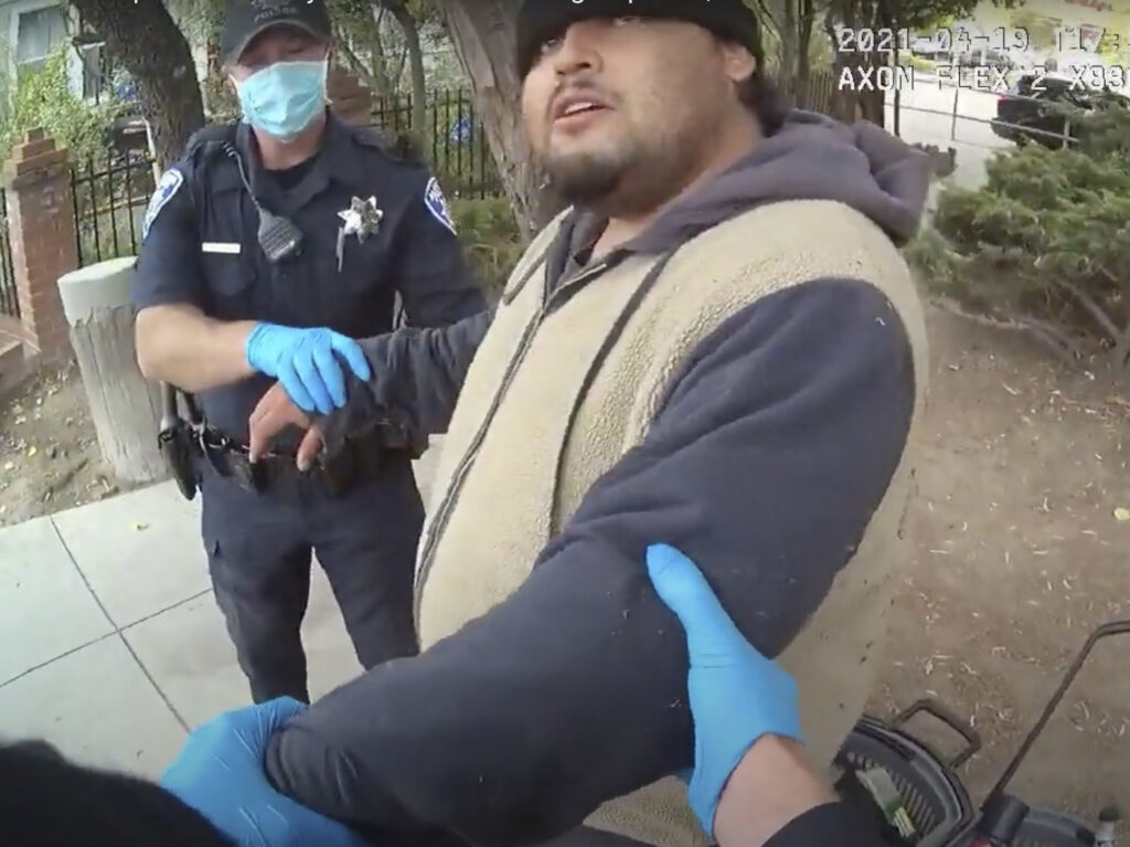 A screenshot of the Alameda Police Department body camera footage shows officers detaining Mario Gonzalez, 26, on April 19. Gonzalez died soon after. CREDIT: Alameda Police Department via AP