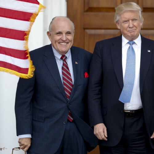 Rudy Giuliani, left, is seen here with Donald Trump shortly after Trump's election victory in 2016. Federal authorities raided Giuliani's apartment Wednesday, the former New York City mayor's attorney said. Carolyn Kaster/AP