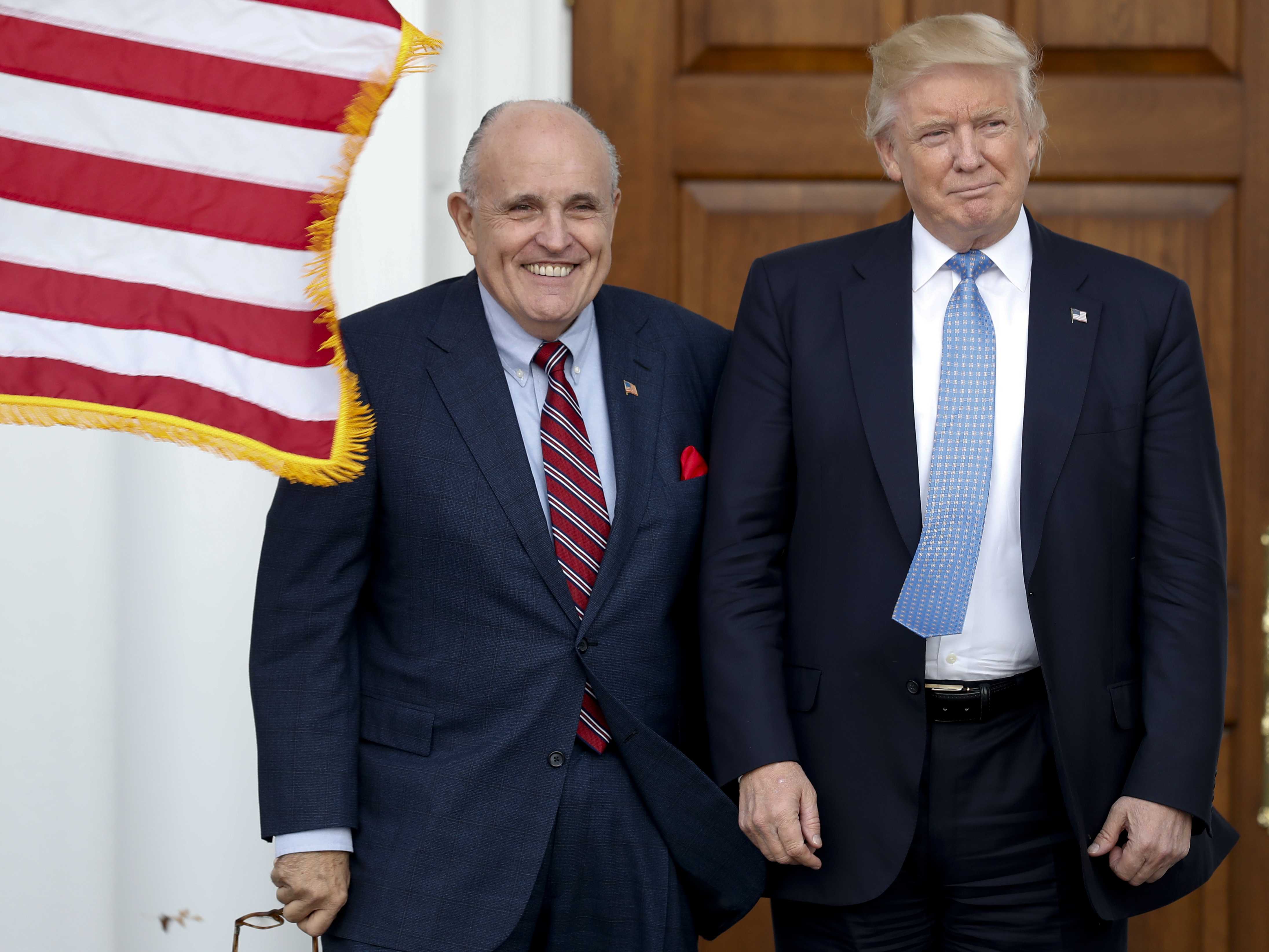 Rudy Giuliani, left, is seen here with Donald Trump shortly after Trump's election victory in 2016. Federal authorities raided Giuliani's apartment Wednesday, the former New York City mayor's attorney said. Carolyn Kaster/AP