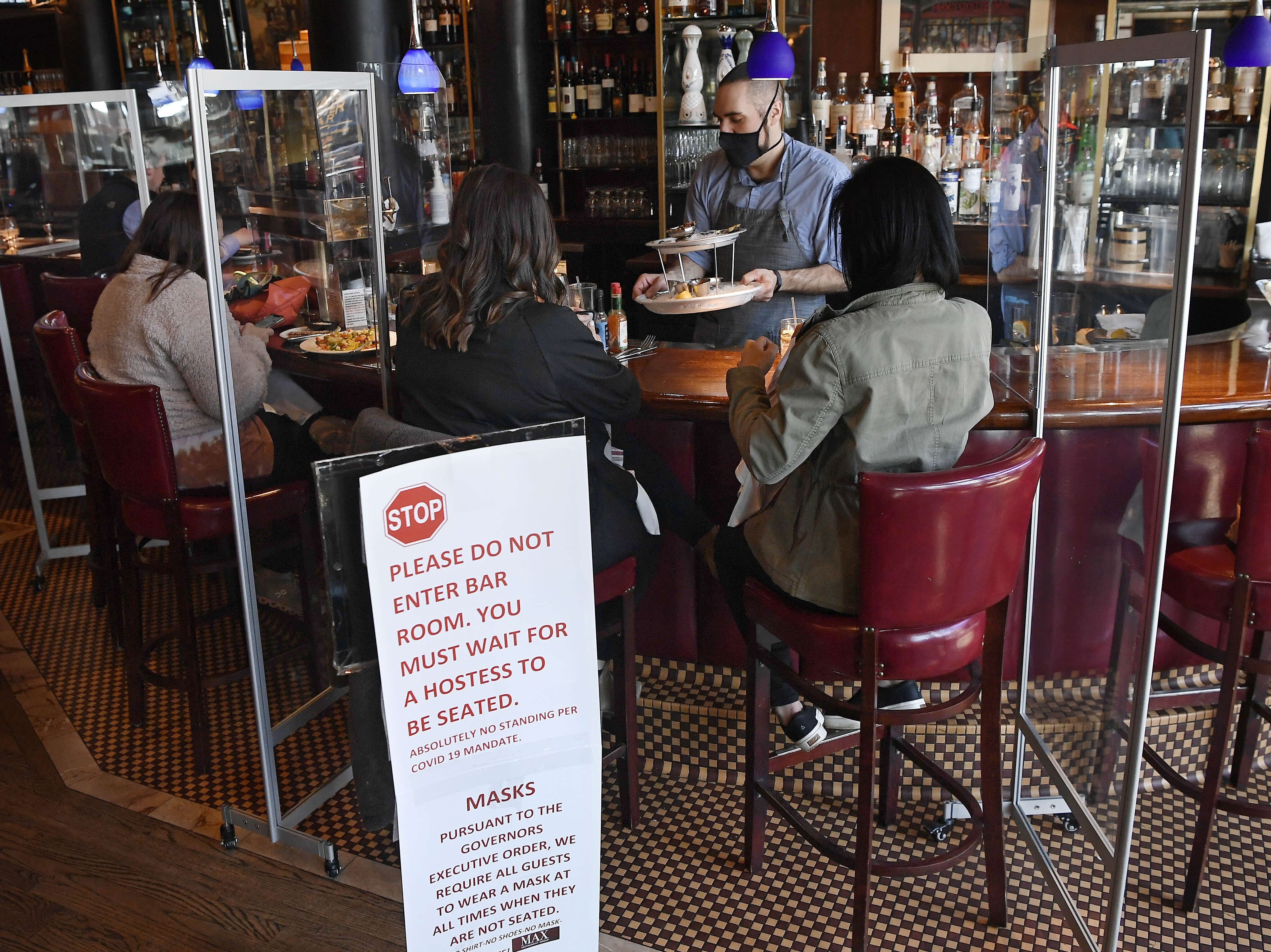 Diners eat lunch at Max's Oyster Bar in West Hartford, Conn., on March 19. Retail sales surged last month as $1,400 relief payments and easing coronavirus restrictions led shoppers to open their wallets. Jessica Hill/AP