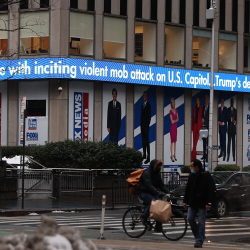 News headlines on the impeachment trial of Donald Trump are displayed outside Fox headquarters in February in New York City. Spencer Platt/Getty Images