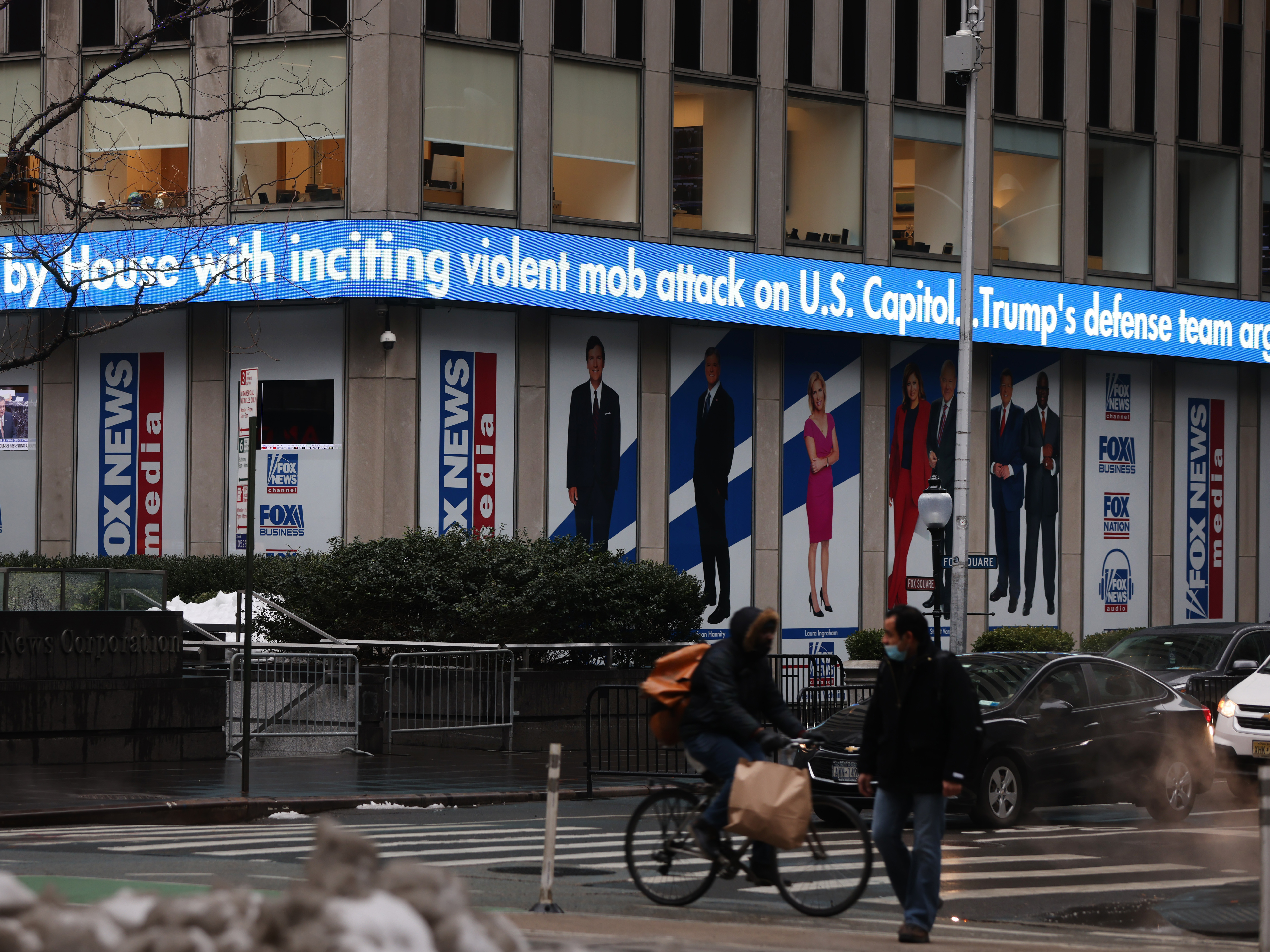 News headlines on the impeachment trial of Donald Trump are displayed outside Fox headquarters in February in New York City. Spencer Platt/Getty Images