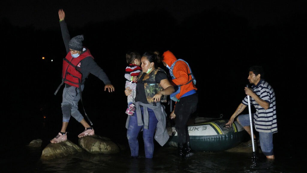 A group of migrants from El Salvador arrives in Roma, Texas, after crossing the Rio Grande on March 30, 2021 in Roma, Texas. CREDIT: Joe Raedle/Getty Images