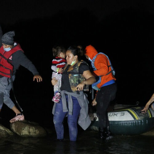 A group of migrants from El Salvador arrives in Roma, Texas, after crossing the Rio Grande on March 30, 2021 in Roma, Texas. CREDIT: Joe Raedle/Getty Images