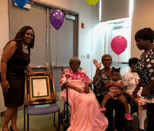 Hester Ford (center) celebrates her birthday in 2019 with her family members. Ford died last Saturday at 115 or 116. CREDIT: Tanisha Patterson-Powe